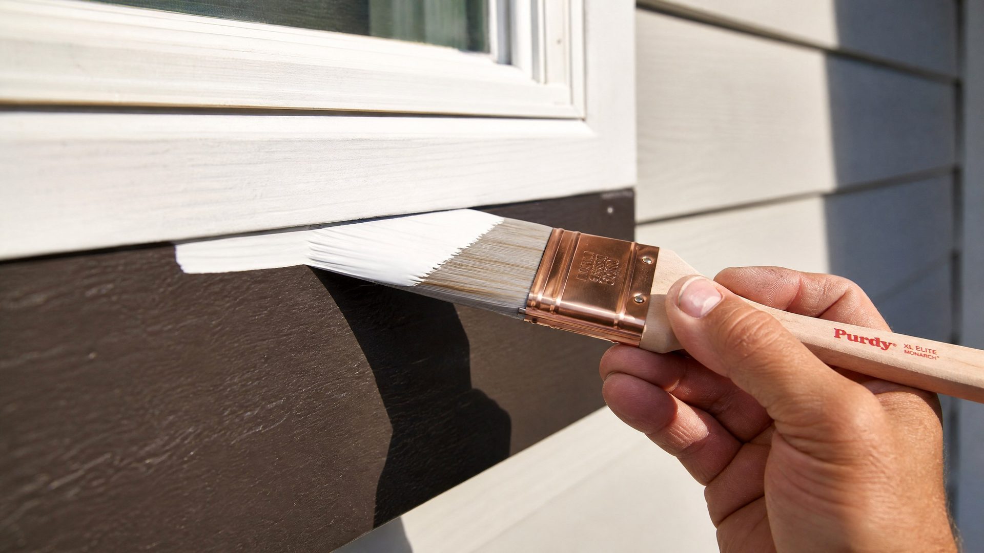 Painter cutting in crisp white exterior trim by hand with a professional brush
